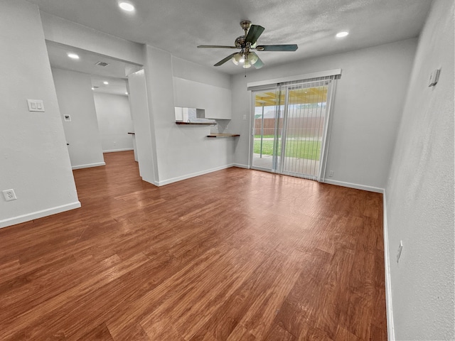 3837 Finley Rd, Irving, TX 75062 - unfurnished living room with ceiling fan, wood finished floors, baseboards, and recessed lighting