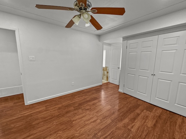 3837 Finley Rd, Irving, TX 75062 - unfurnished bedroom with baseboards, wood finished floors, a closet, and a ceiling fan