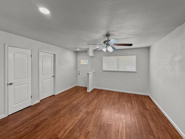 3837 Finley Rd, Irving, TX 75062 - unfurnished living room featuring wood finished floors, a ceiling fan, a textured ceiling, and baseboards