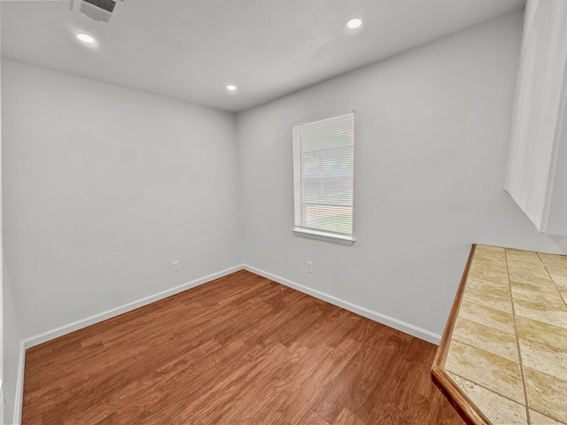3837 Finley Rd, Irving, TX 75062 - empty room featuring wood finished floors, baseboards, and recessed lighting