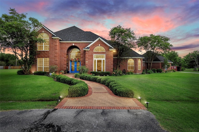 226 Northline Rd, Teague, TX 75860 - traditional-style home featuring brick siding, a front yard, and a shingled roof
