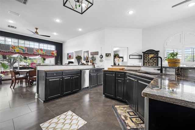226 Northline Rd, Teague, TX 75860 - kitchen featuring ceiling fan, a sink, crown molding, dark cabinets, and recessed lighting
