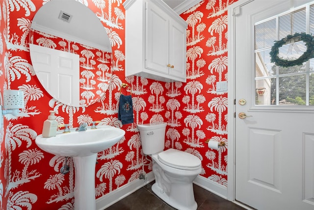 226 Northline Rd, Teague, TX 75860 - bathroom with wallpapered walls, baseboards, crown molding, toilet, and tile patterned floors