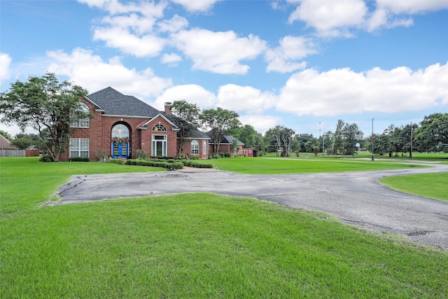 226 Northline Rd, Teague, TX 75860 - view of front of home with brick siding, a front yard, and a chimney