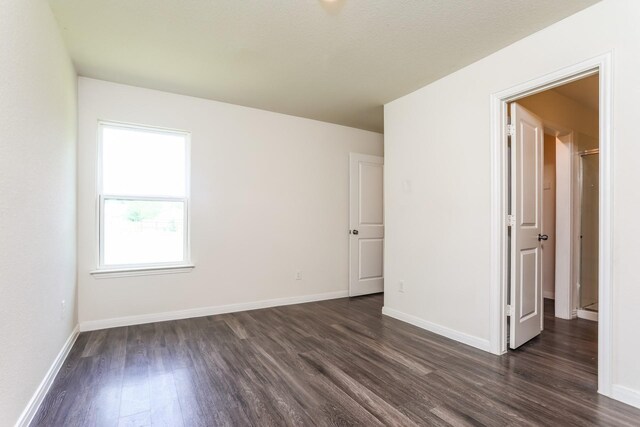 2515 Lyle Ave, Waco, TX 76708 - unfurnished bedroom with dark wood-style flooring and baseboards