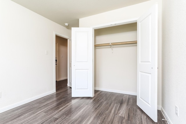 2515 Lyle Ave, Waco, TX 76708 - unfurnished bedroom featuring dark wood-style floors, a closet, and baseboards