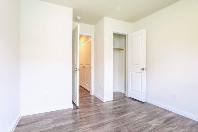 2515 Lyle Ave, Waco, TX 76708 - unfurnished bedroom with wood finished floors, baseboards, and a closet