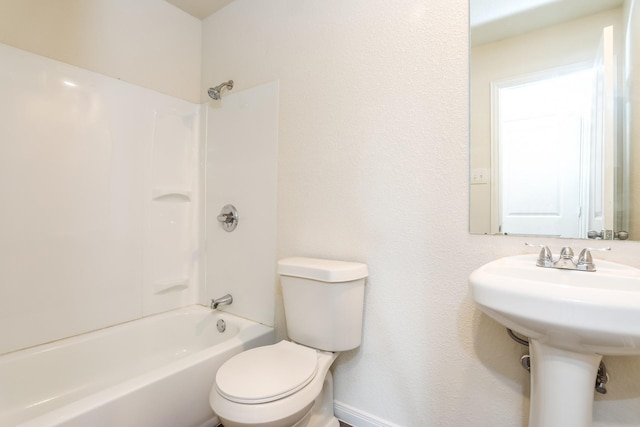 2515 Lyle Ave, Waco, TX 76708 - bathroom featuring toilet, shower / washtub combination, a sink, and baseboards