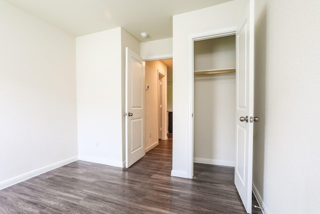 2515 Lyle Ave, Waco, TX 76708 - unfurnished bedroom featuring dark wood-style flooring, a closet, and baseboards