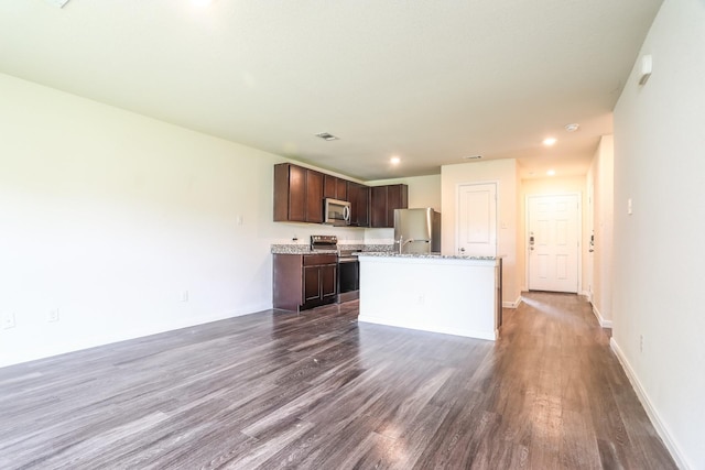 2515 Lyle Ave, Waco, TX 76708 - kitchen featuring appliances with stainless steel finishes, dark wood finished floors, dark brown cabinetry, a kitchen island, and baseboards