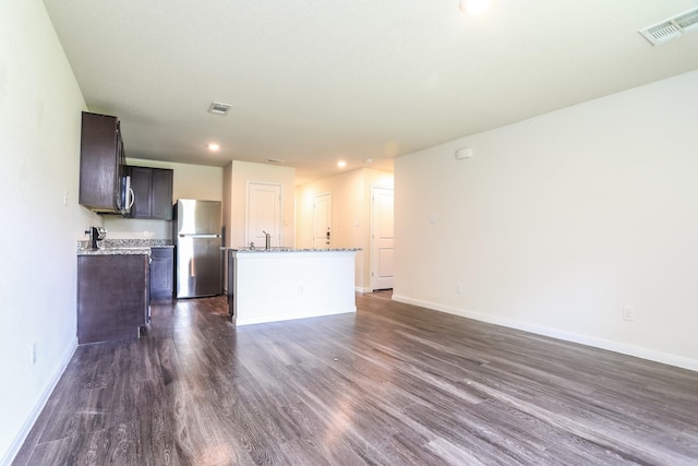 2515 Lyle Ave, Waco, TX 76708 - unfurnished living room featuring dark wood finished floors, baseboards, and recessed lighting