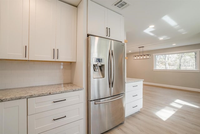 890 Nash Ln, Lipan, TX 76462 - kitchen featuring stainless steel refrigerator with ice dispenser, decorative backsplash, white cabinets, light wood-type flooring, and baseboards