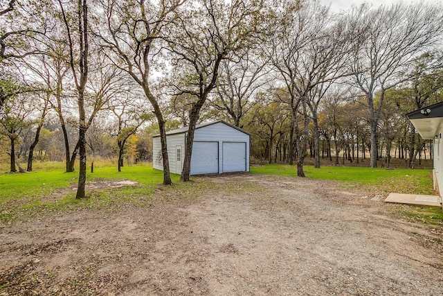890 Nash Ln, Lipan, TX 76462 - view of grassy yard featuring an outbuilding, a detached garage, and driveway