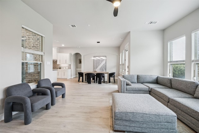 4871 Lockwood Dr, Prosper, TX 75078 - living area featuring arched walkways, light wood finished floors, ceiling fan, and recessed lighting