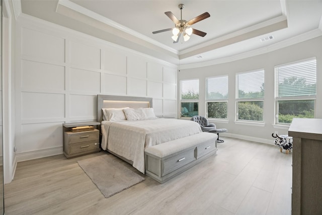 4871 Lockwood Dr, Prosper, TX 75078 - bedroom with a decorative wall, a raised ceiling, light wood finished floors, ornamental molding, and ceiling fan