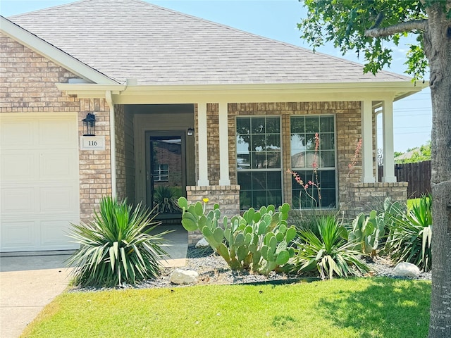 116 Bison Meadow Dr, Waxahachie, TX 75165 - doorway to property featuring a shingled roof, an attached garage, brick siding, and a porch