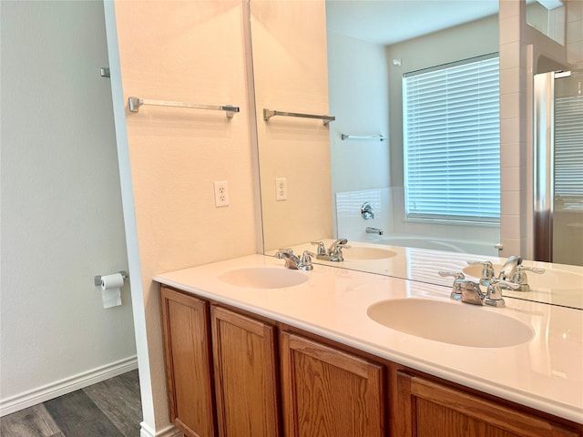 116 Bison Meadow Dr, Waxahachie, TX 75165 - bathroom with a garden tub, double vanity, wood finished floors, and a shower with shower door