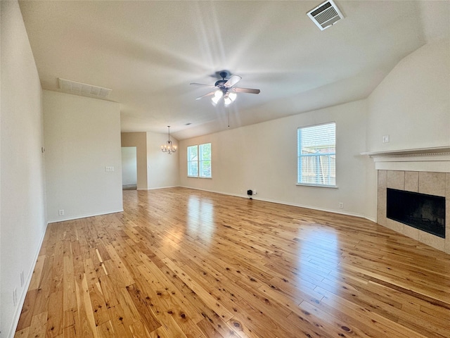 116 Bison Meadow Dr, Waxahachie, TX 75165 - unfurnished living room with hardwood / wood-style flooring, a chandelier, ceiling fan, a tiled fireplace, and baseboards