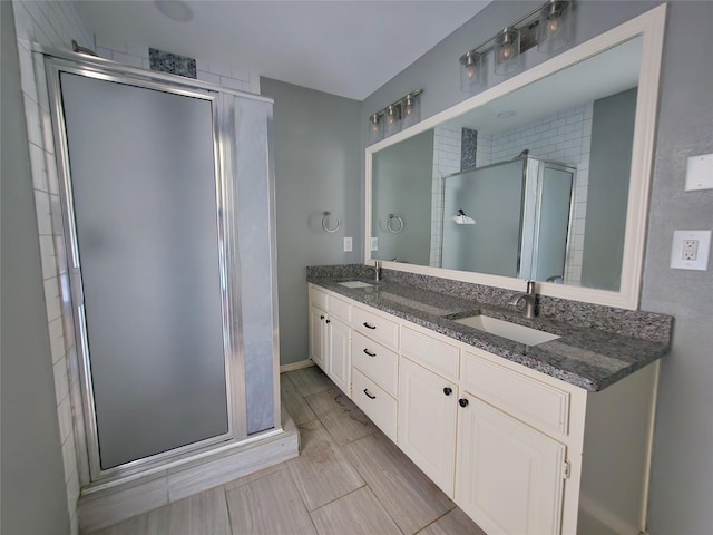 338 Wildbriar Dr, Garland, TX 75043 - full bathroom with a stall shower, double vanity, and baseboards