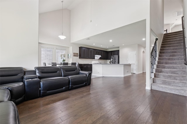 824 Water Garden Cir, Little Elm, TX 75068 - living area featuring high vaulted ceiling, dark wood-style floors, and stairs