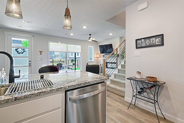 841 Emerling Dr, Mckinney, TX 75069 - kitchen with stainless steel dishwasher, light wood-style flooring, plenty of natural light, open floor plan, and recessed lighting