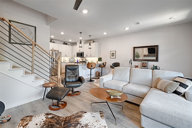 841 Emerling Dr, Mckinney, TX 75069 - living area with stairway, light wood-style flooring, recessed lighting, baseboards, and ceiling fan