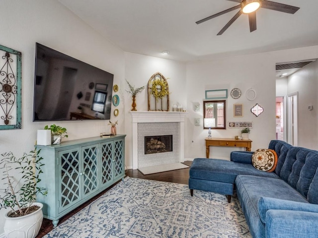 1676 Castle Pines Dr, Frisco, TX 75036 - living room featuring ceiling fan, wood finished floors, a tile fireplace, and baseboards