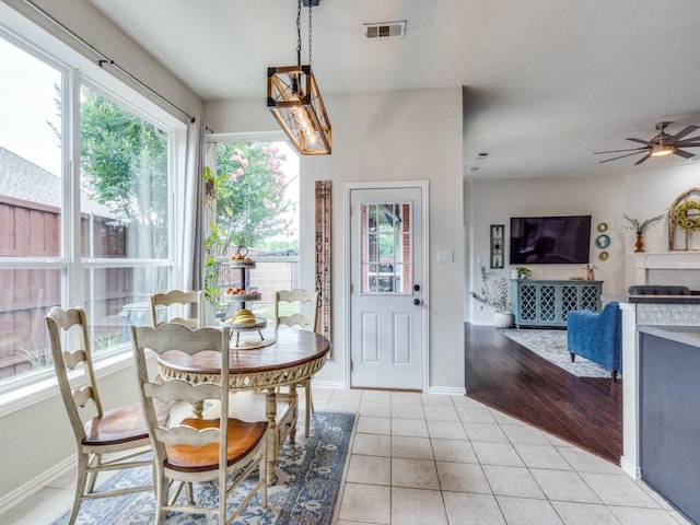 1676 Castle Pines Dr, Frisco, TX 75036 - dining space featuring light tile patterned floors, ceiling fan, baseboards, and a chandelier
