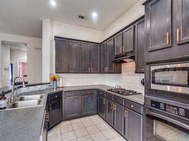 1676 Castle Pines Dr, Frisco, TX 75036 - kitchen featuring oven, a sink, stainless steel microwave, gas cooktop, and light tile patterned flooring