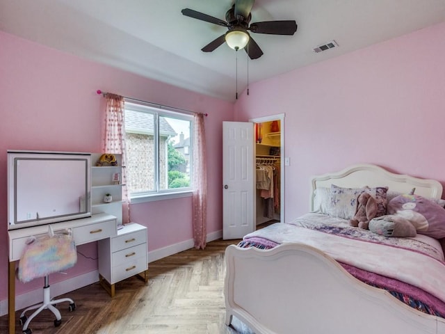 1676 Castle Pines Dr, Frisco, TX 75036 - bedroom with baseboards, a spacious closet, and a ceiling fan