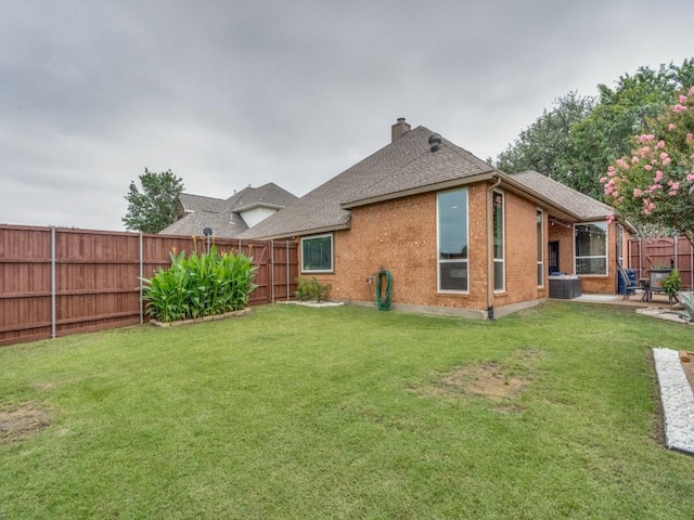 1676 Castle Pines Dr, Frisco, TX 75036 - rear view of property with a chimney, brick siding, a patio area, roof with shingles, and central air condition unit