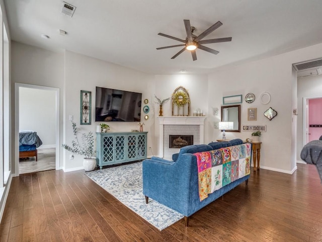 1676 Castle Pines Dr, Frisco, TX 75036 - living room featuring a ceiling fan, dark wood-type flooring, a fireplace, and baseboards
