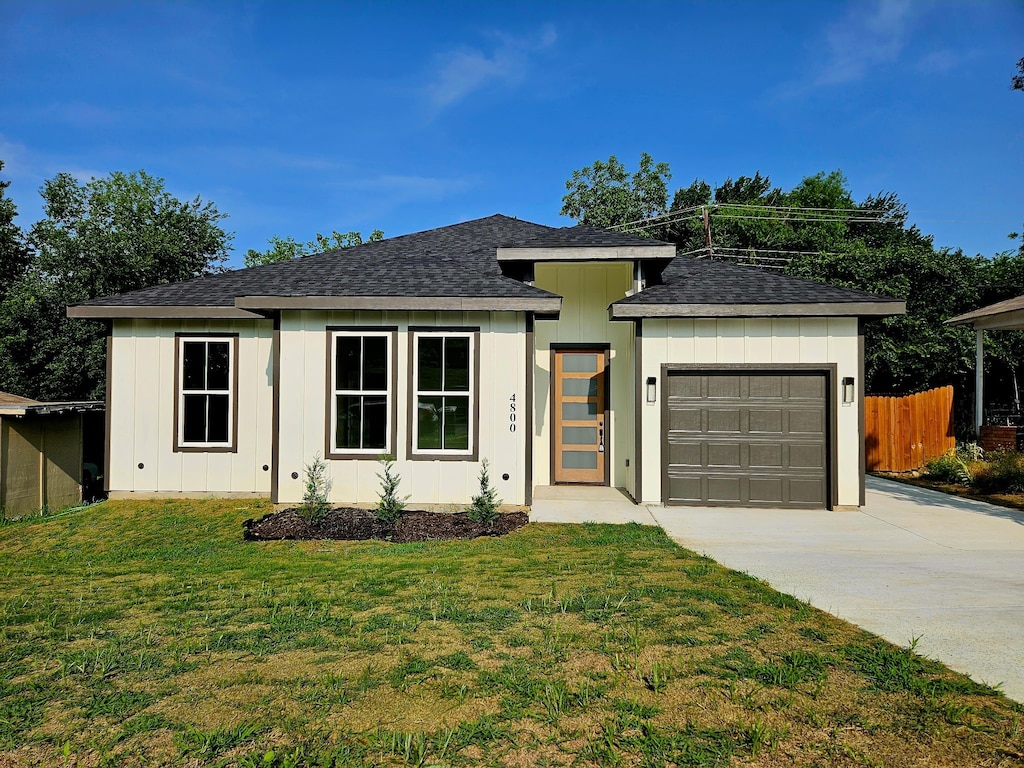 4800 Littlepage St, Fort Worth, TX 76107 - prairie-style home with a garage, concrete driveway, board and batten siding, and roof with shingles