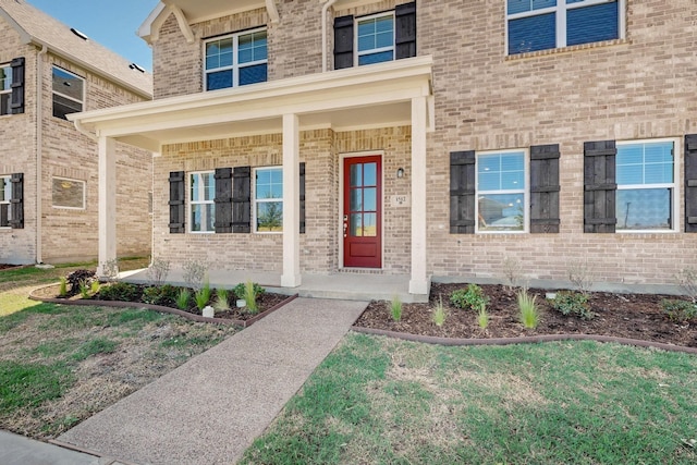 1808 Summer Aura, Mesquite, TX 75181 - property entrance with brick siding, a porch, and a yard