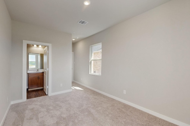 1808 Summer Aura, Mesquite, TX 75181 - unfurnished bedroom featuring dark carpet, baseboards, recessed lighting, connected bathroom, and a sink