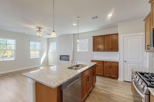 1804 Summer Aura, Mesquite, TX 75181 - kitchen with appliances with stainless steel finishes, a sink, light wood-type flooring, brown cabinets, and recessed lighting