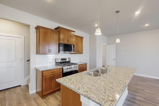 1804 Summer Aura, Mesquite, TX 75181 - kitchen with appliances with stainless steel finishes, a sink, brown cabinetry, light wood-style floors, and recessed lighting