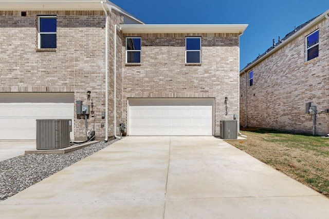 1804 Summer Aura, Mesquite, TX 75181 - back of property with a garage, central air condition unit, concrete driveway, and brick siding