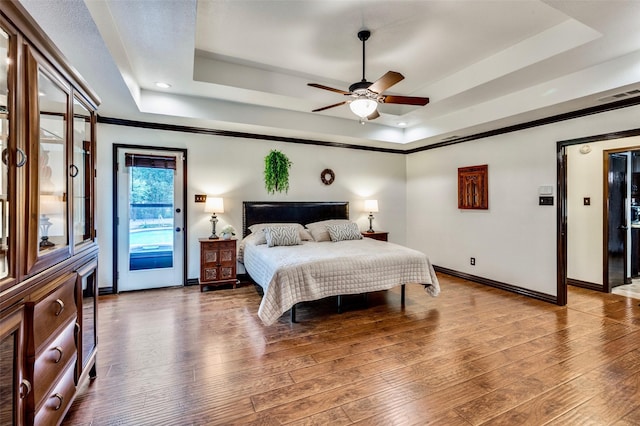 1345 Meadow Gln, Southlake, TX 76092 - bedroom with a tray ceiling, access to outside, baseboards, wood finished floors, and recessed lighting