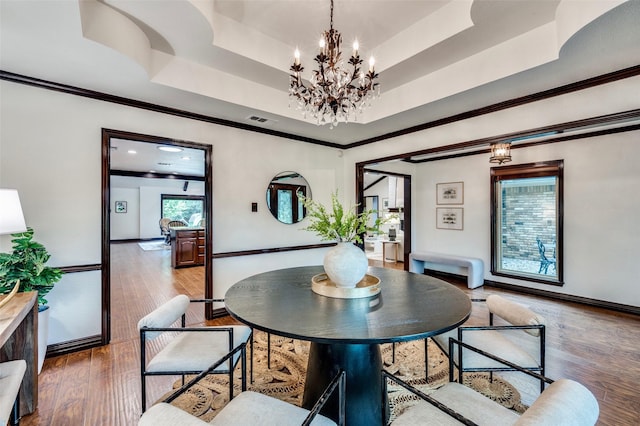 1345 Meadow Gln, Southlake, TX 76092 - dining room featuring a chandelier, ornamental molding, wood finished floors, a tray ceiling, and baseboards