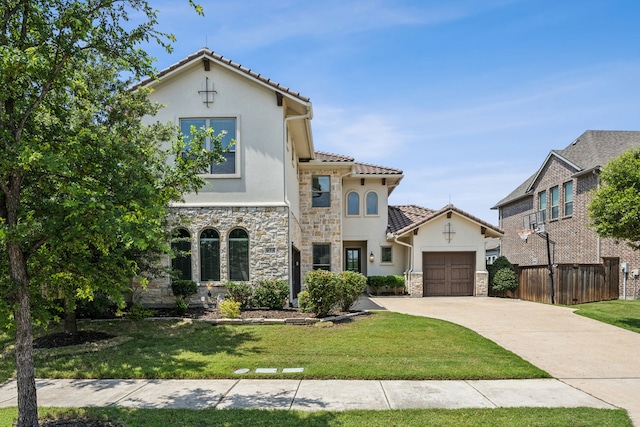 975 Stampede Dr, Frisco, TX 75036 - mediterranean / spanish-style house featuring stone siding, stucco siding, an attached garage, driveway, and a tile roof