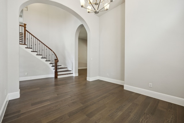 975 Stampede Dr, Frisco, TX 75036 - spare room with dark wood-style flooring, a chandelier, stairway, and baseboards