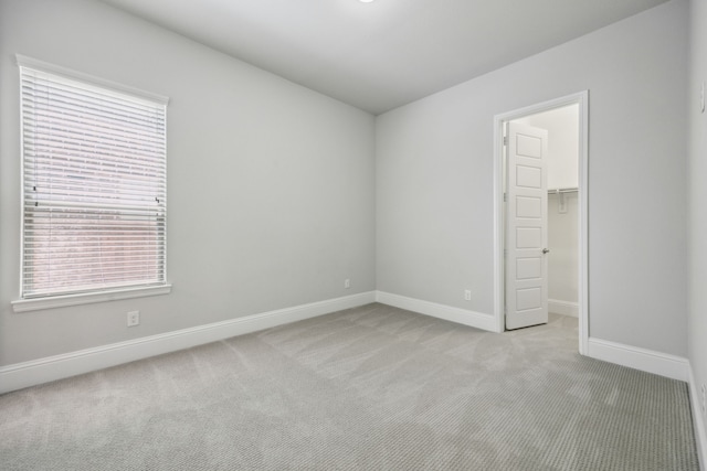 975 Stampede Dr, Frisco, TX 75036 - unfurnished bedroom with light carpet, a spacious closet, baseboards, and a closet
