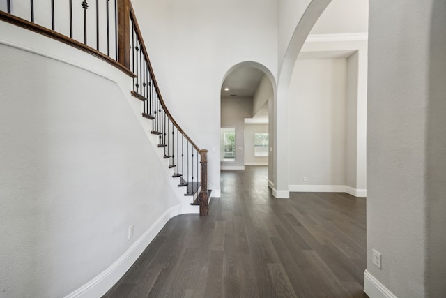 975 Stampede Dr, Frisco, TX 75036 - foyer with arched walkways, dark wood-type flooring, baseboards, stairs, and a towering ceiling