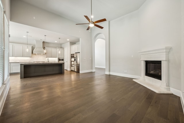 975 Stampede Dr, Frisco, TX 75036 - unfurnished living room with a ceiling fan, recessed lighting, a premium fireplace, dark wood-style floors, and baseboards