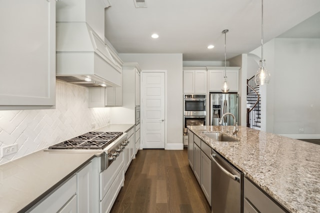 975 Stampede Dr, Frisco, TX 75036 - kitchen featuring a sink, stainless steel appliances, dark wood-style floors, baseboards, and decorative backsplash