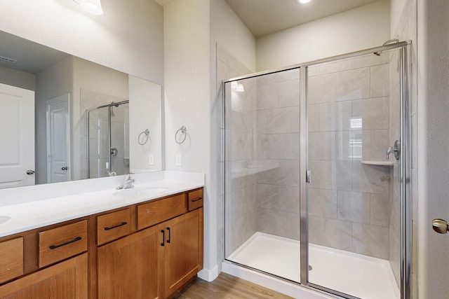 1812 Summer Aura, Mesquite, TX 75181 - bathroom with double vanity, a stall shower, and wood finished floors