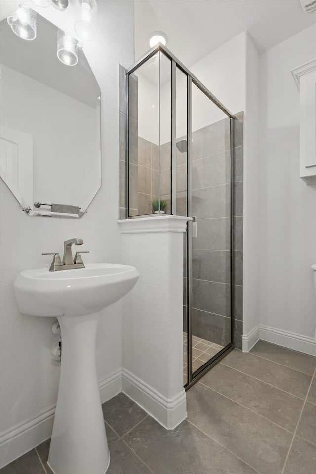 2821 White Plains Dr, Midlothian, TX 76065 - full bath with tile patterned flooring, a shower stall, baseboards, and a sink