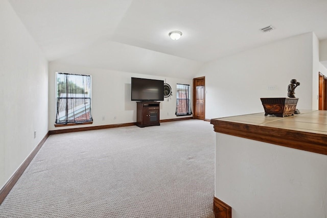 11873 Lampwick Ln, Frisco, TX 75035 - unfurnished living room with healthy amount of natural light, vaulted ceiling, baseboards, and light carpet
