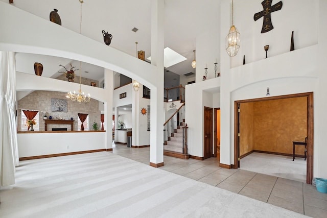11873 Lampwick Ln, Frisco, TX 75035 - unfurnished living room featuring a chandelier, carpet flooring, high vaulted ceiling, tile patterned floors, and stairway